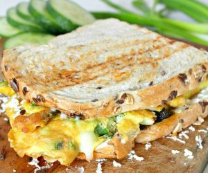 Omelette sandwich with sun dried tomatoes, cheese & green onions