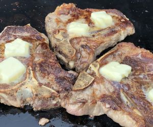 T-bone steaks with mushrooms and onions on a Blackstone Griddle